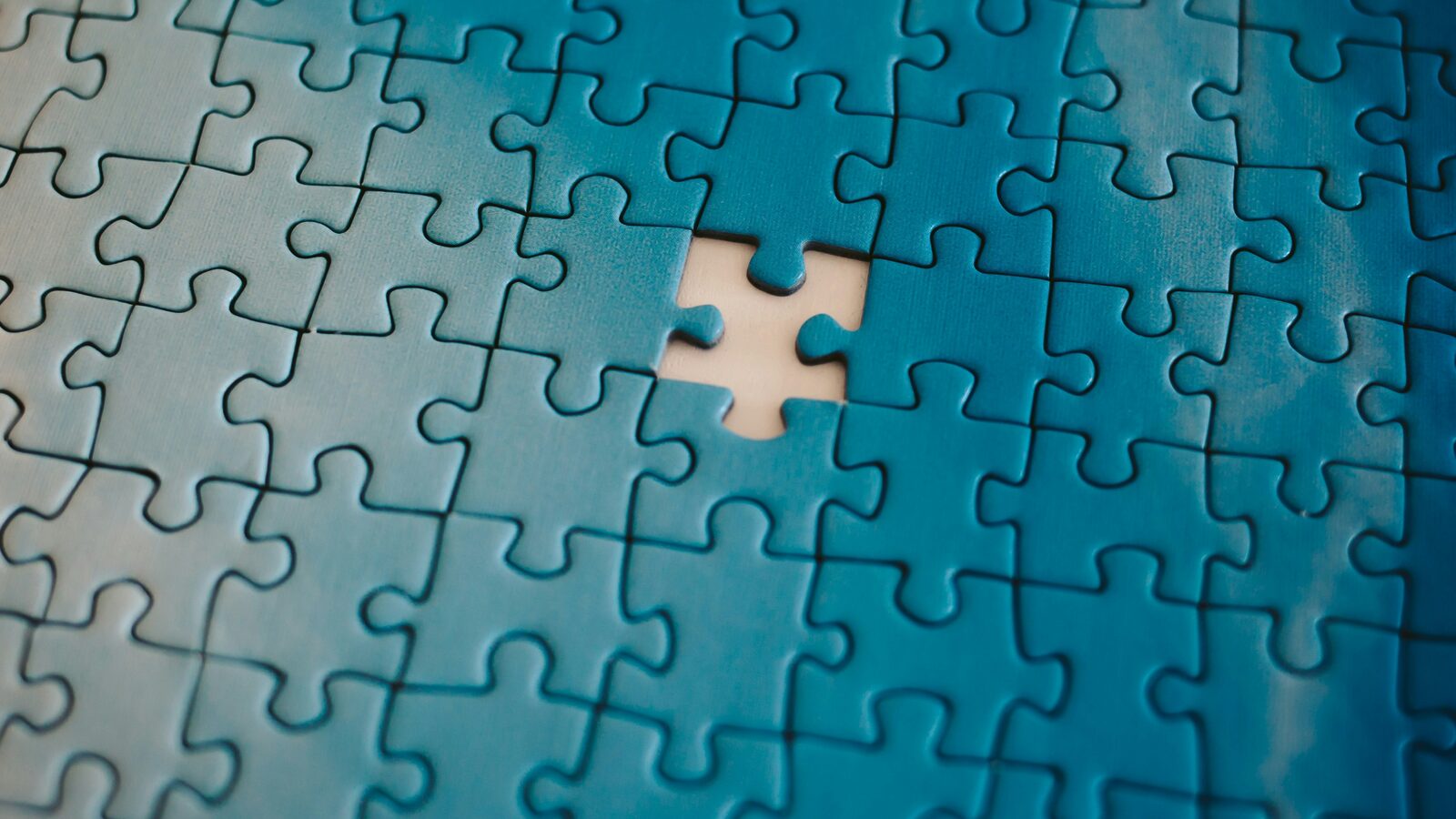 An assembled jigsaw puzzle with one piece missing from the middle