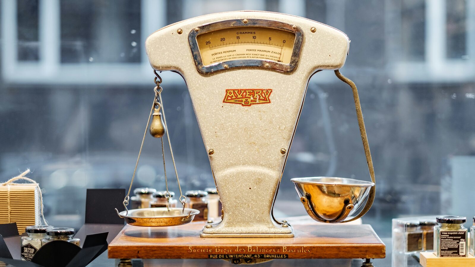 An old two-pan balance scale standing on a flat surface